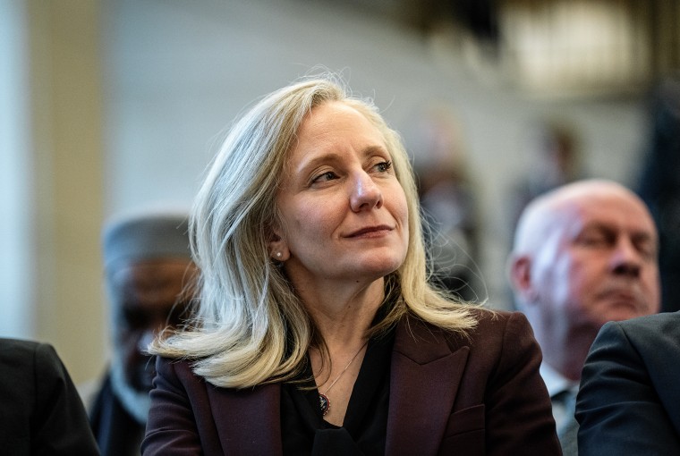 Abigail Spanberger smiles as she looks over her left shoulder.