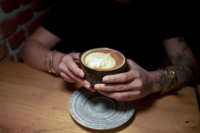A person holding a cup of coffee