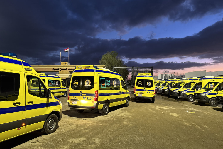 Ambulances wait on the Egyptian side of the Rafah border crossing with the Gaza Strip on February 4.