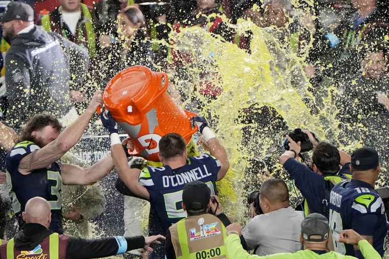Head coach Mike MacDonald of the Seattle Seahawks is doused with Gatorade by Patrick O'Connell #52 of the Seattle Seahawks after beating New England Patriots to win Super Bowl LX at Levi's Stadium on February 08, 2026 in Santa Clara, California.  
