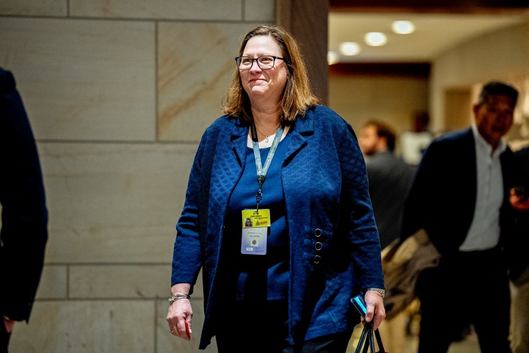 Julie Johnson smiles while walking in the halls of the U.S. Capitol building