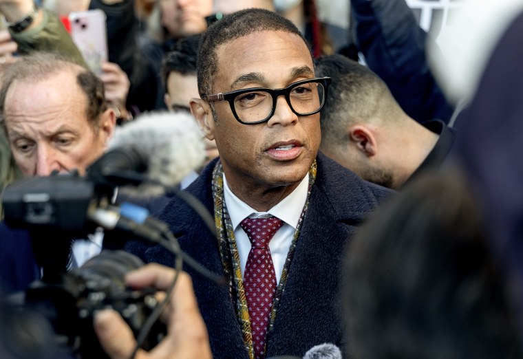 Don Lemon is surrounded by cameras and reporters. 