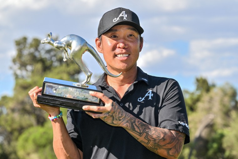 4Aces GC player Anthony Kim from the U.S. celebrates with the trophy after winning the LIV Golf Adelaide tournament on February 15.