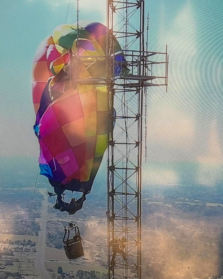 Rescue mission after a hot air balloon basket carrying two occupants struck a cell phone tower at an estimated height of 920 feet in north Gregg County.