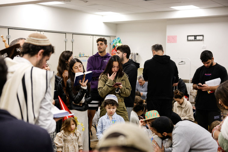 Israelis gather in a bomb shelter after missiles were launched towards Israel from Iran, in Tel Aviv