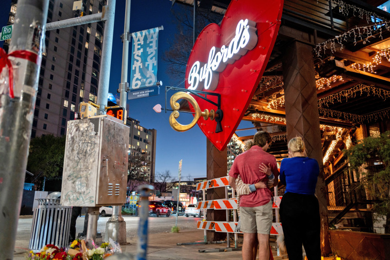 People pay homage to the shooting victims at a makeshift memorial outside of Buford's bar in on March 2, 2026 in Austin, Texas. 