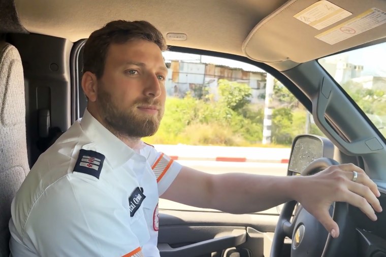 Itai Orion driving an ambulance.