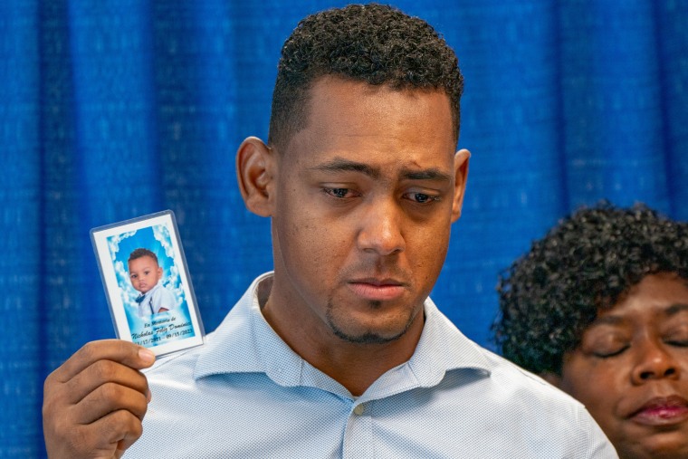 Otoniel Feliz holds a photo of his deceased infant son, Nicholas Feliz Dominici
