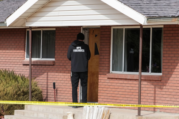A forensic scientist enters a home.