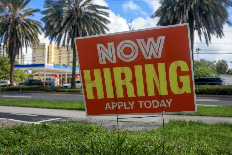 Now Hiring sign.