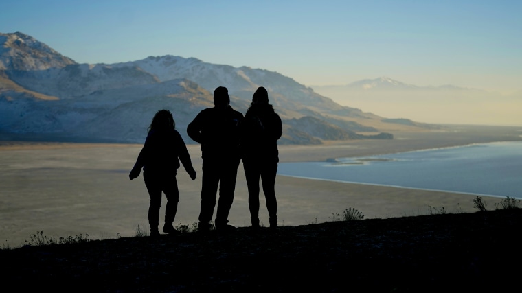 Antelope Island State Park visitors view a dry lake bed at the receding edge of the Great Salt Lake in 2022.