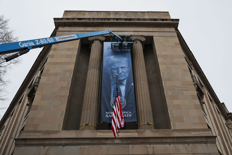 A banner of President Donald Trump is hung on the Department of Justice on Feb. 19, 2026.