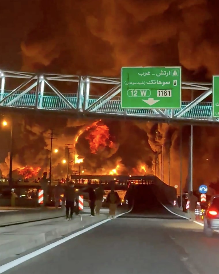 A still from a video shared on social media Sunday and verified by NBC News shows the fiery aftermath of an airstrike on an oil depot in northeast Tehran.