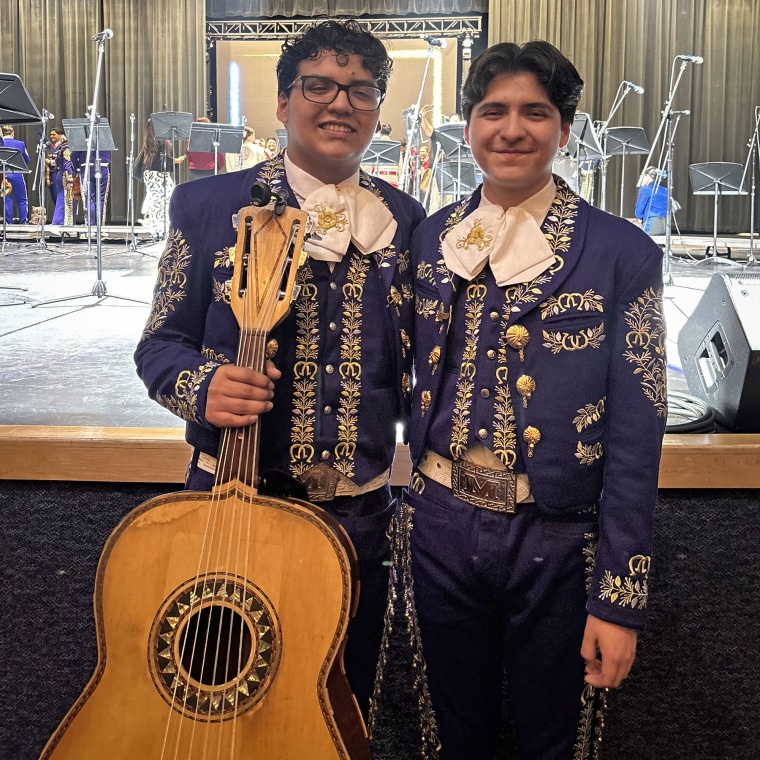 Antonio, third from left, and Caleb Gámez-Cuéllar, hold a trophy surrounded by their brother, mother and father.
