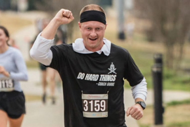 Jason Hughes raises a fist while running
