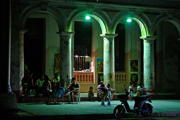 Cubans gather in front of their houses during a blackout in Havana.