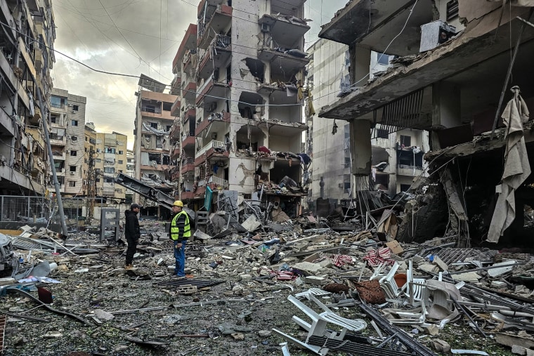 Men inspect a site of overnight Israeli airstrikes in the southern suburbs of Beirut on March 16, 2026. 