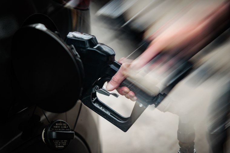 A person pumps gas at Penn Jersey Mart gas station, the image shows fast movement with a lens filter
