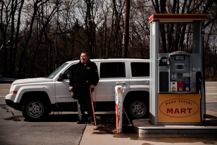 Roy Strohecker poses for a portrait in front of his car at Penn Jersey Mart gas station