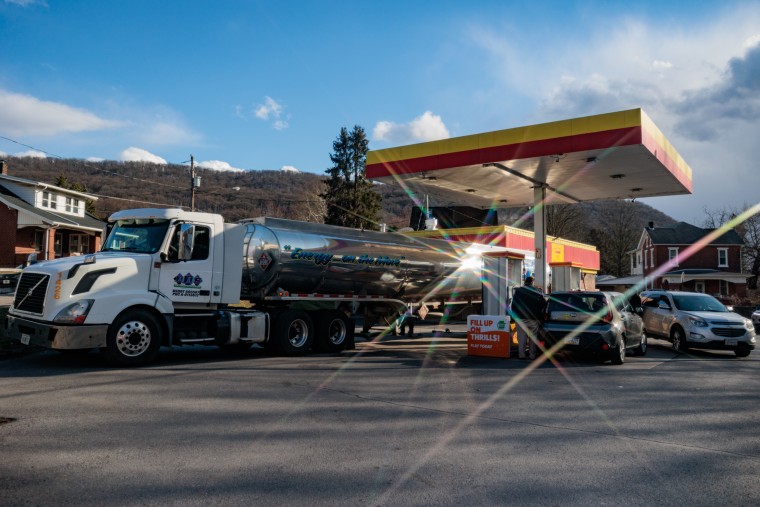 A large truck parked at a gas station