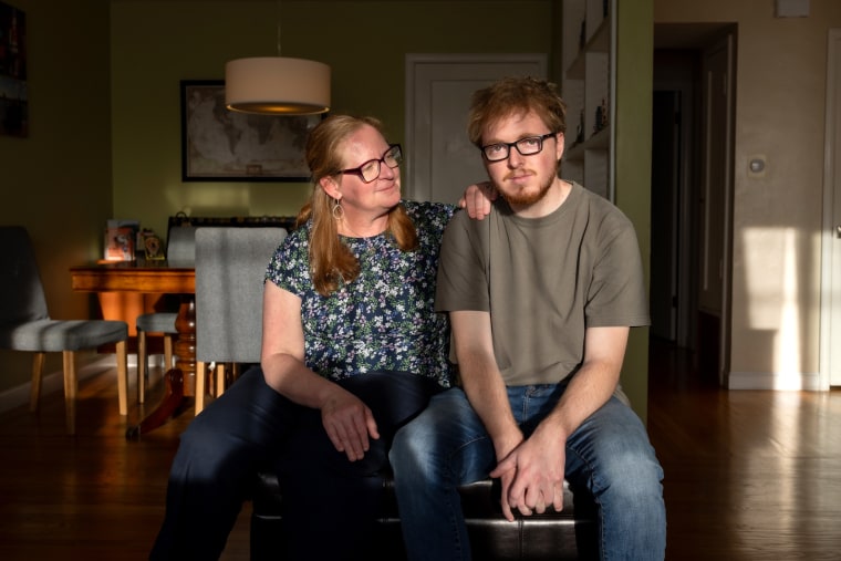 Kim looks at her son, Kurt, at their home.