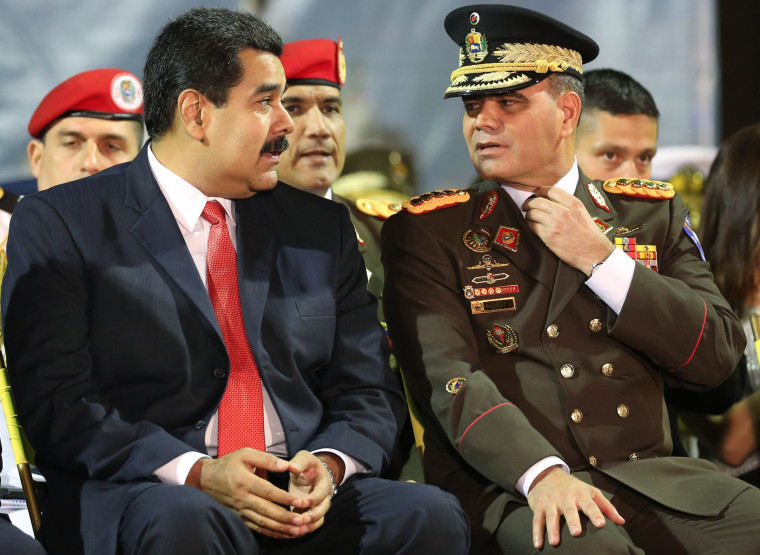 Venezuela’s President Nicolas Maduro, left, speaks with new Defense Minister Gen. Vladimir Padrino, during the new military chief's swearing-in ceremony