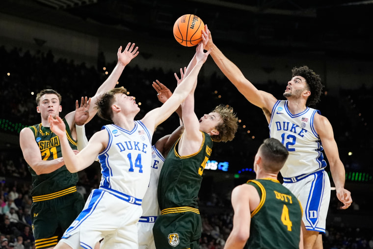 Duke forward Cameron Boozer (12) tries to shoot against Siena on the basketball court