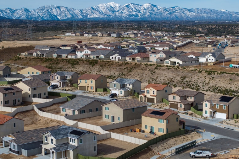 In an aerial view, snow on the San Gabriel Mountains is visible in the distance as houses are constructed at the massive 9,000-acre master-planned Silverwood community project