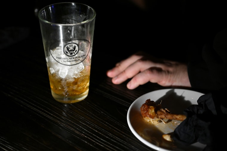 A glass with an emblem for the Polymarket bar “The Situation Room.”