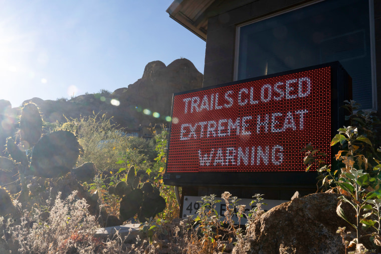 A digital sign reads TRAILS CLOSED EXTREME HEAT WARNING.