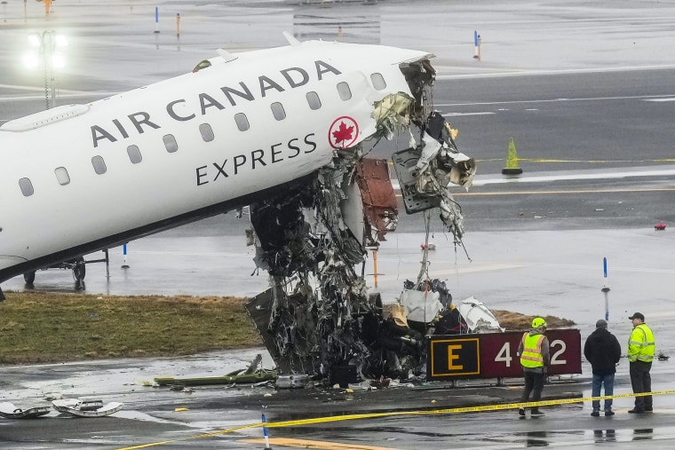 A destroyed plane is seen on the tarmac outside