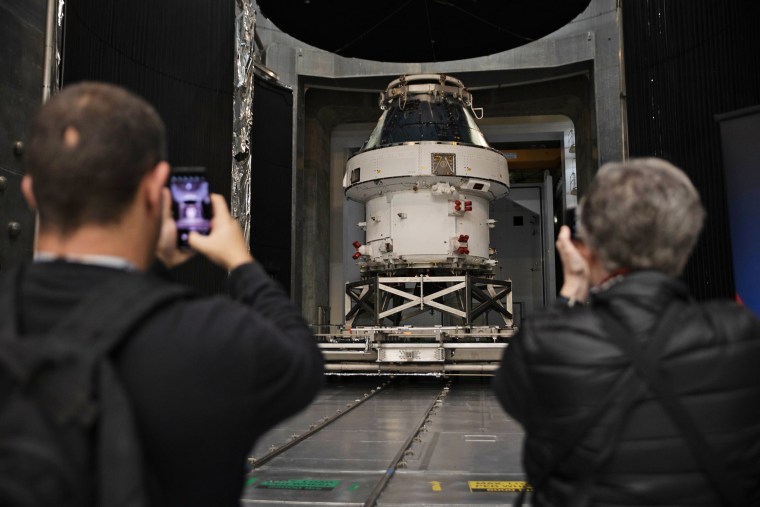 Spectators take photos at the unveiling of the Orion Space
