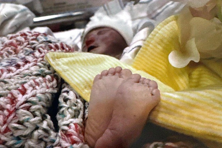 A baby wrapped in a blanket