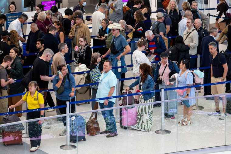 Travelers wait in line at George Bush International Airport on March 19 in Houston.Antranik Tavitian / Getty Images