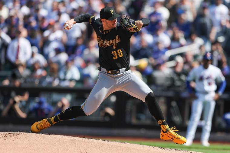 Paul Skenes takes a long stride while throwing a pitch.