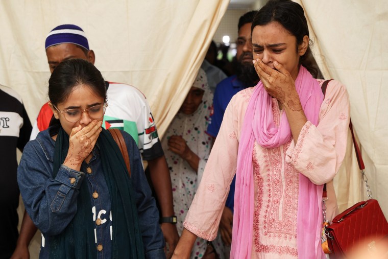 Image: Relatives of victims crying at Rajbari Government Hospital
