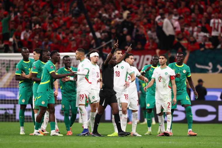 A referee calls for video review during the final between Senegal and Morocco on Jan. 18, 2026. 