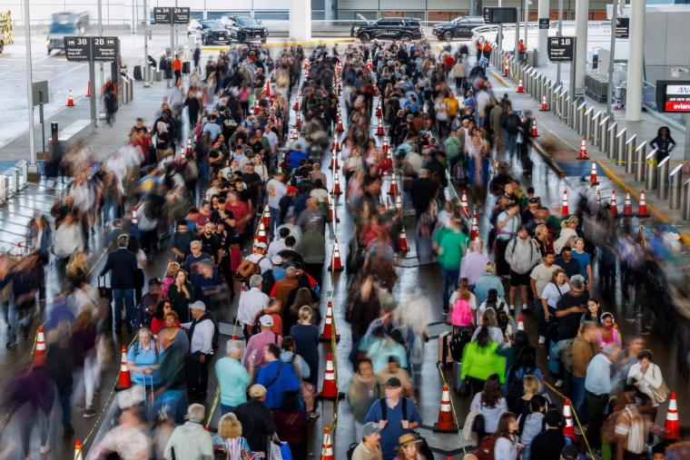 Travelers wait in line at a Transportation Security Administration (TSA) checkpoint at George Bush Intercontinental Airport (IAH) in Houston, Texas.