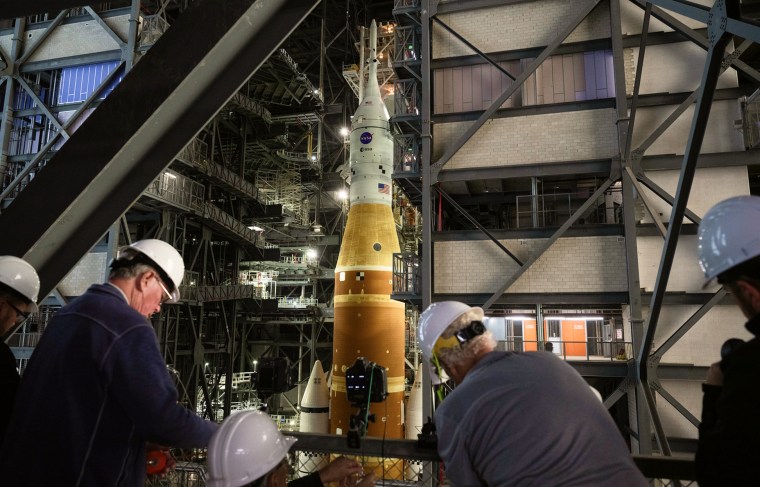 Members of the media set up remote cameras to photograph the rollout of NASA’s Artemis II rocket on Jan. 16.