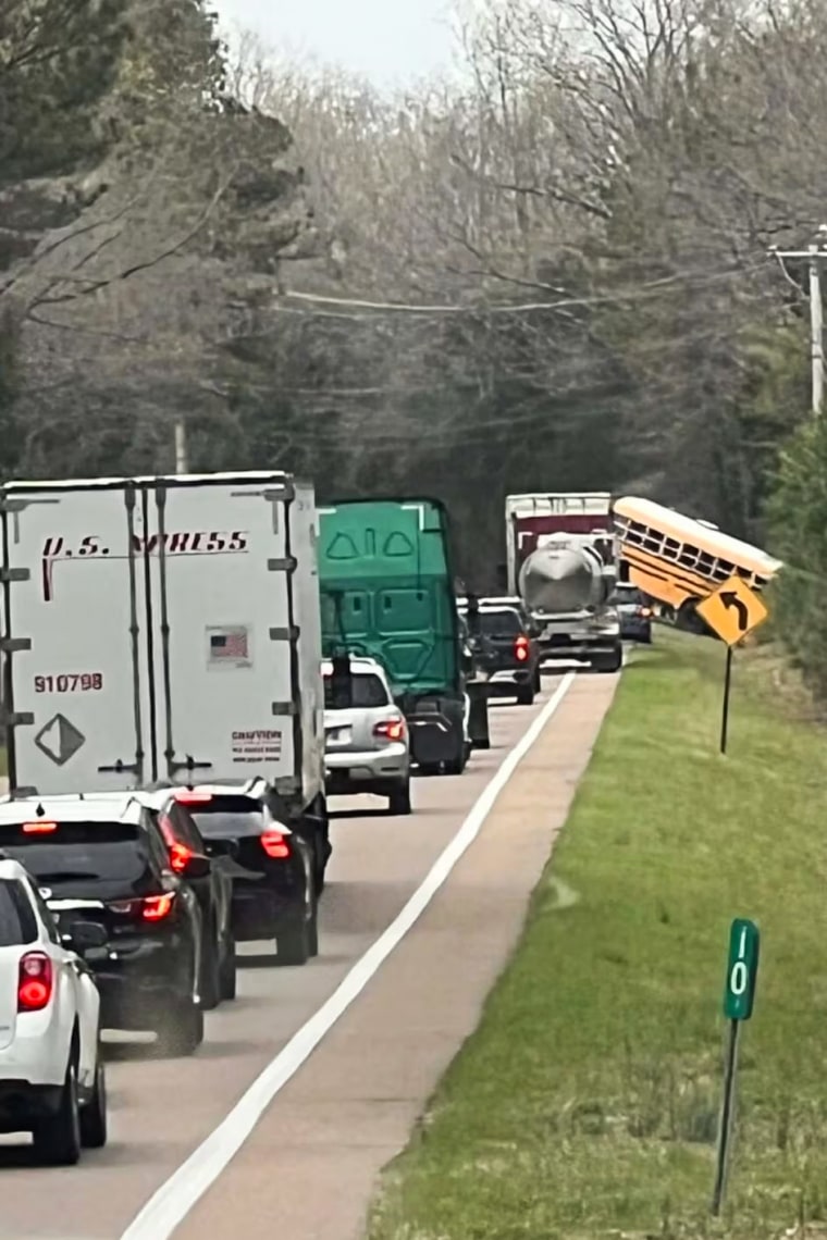 A view from the scene shows a long line of traffic in front of a tipped school bus after a fatal crash in Carroll County, Tenn.