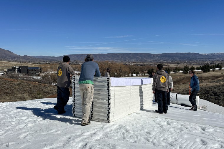 Soldier Hollow Nordic Center staff use a snowmobile to position Snow Secure over
