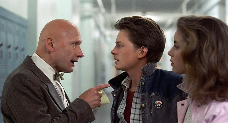 James Tolkan, left, points at Michael J. Fox, and Claudia Wells in a school hallway