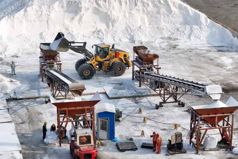 Urea fertilizer is sorted astatine a dock earlier being loaded onto ships astatine a port