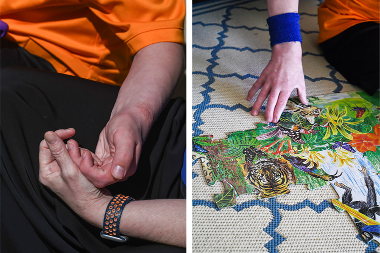 Cole loves doing puzzles, which his mother, seen holding Cole's hand at left, treasures watching him still have the ability to do. 