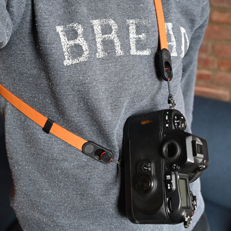 A close up of the Peak Design Form Leather Camera Strap worn by NBC Select reporter Harry Rabinowitz.