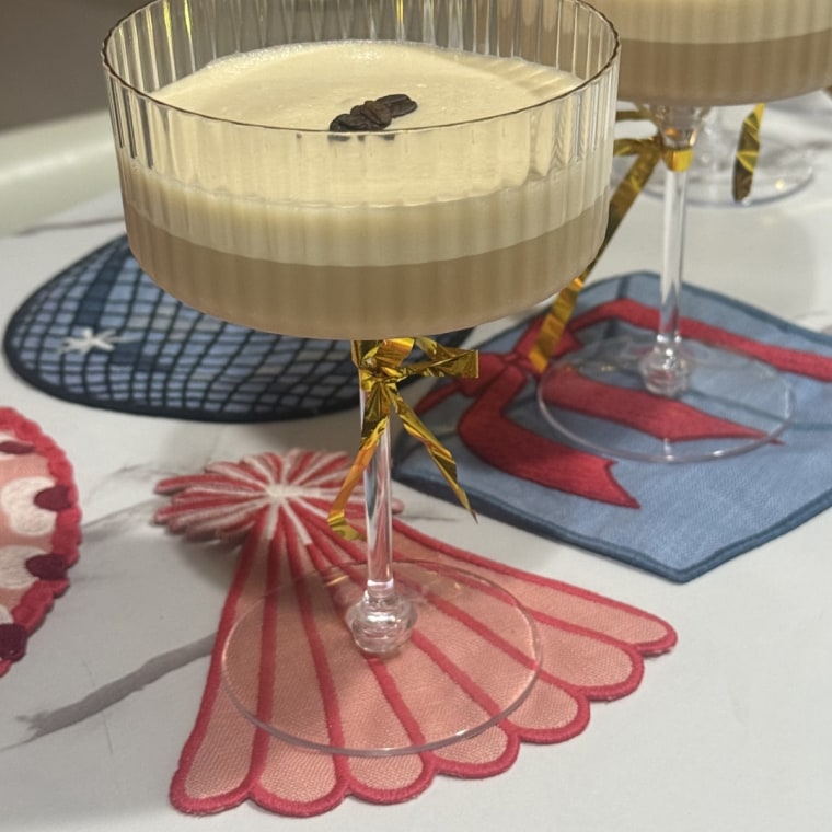 Cocktail glasses on a table with Piecework Puzzles Birthday Cocktail Napkins.