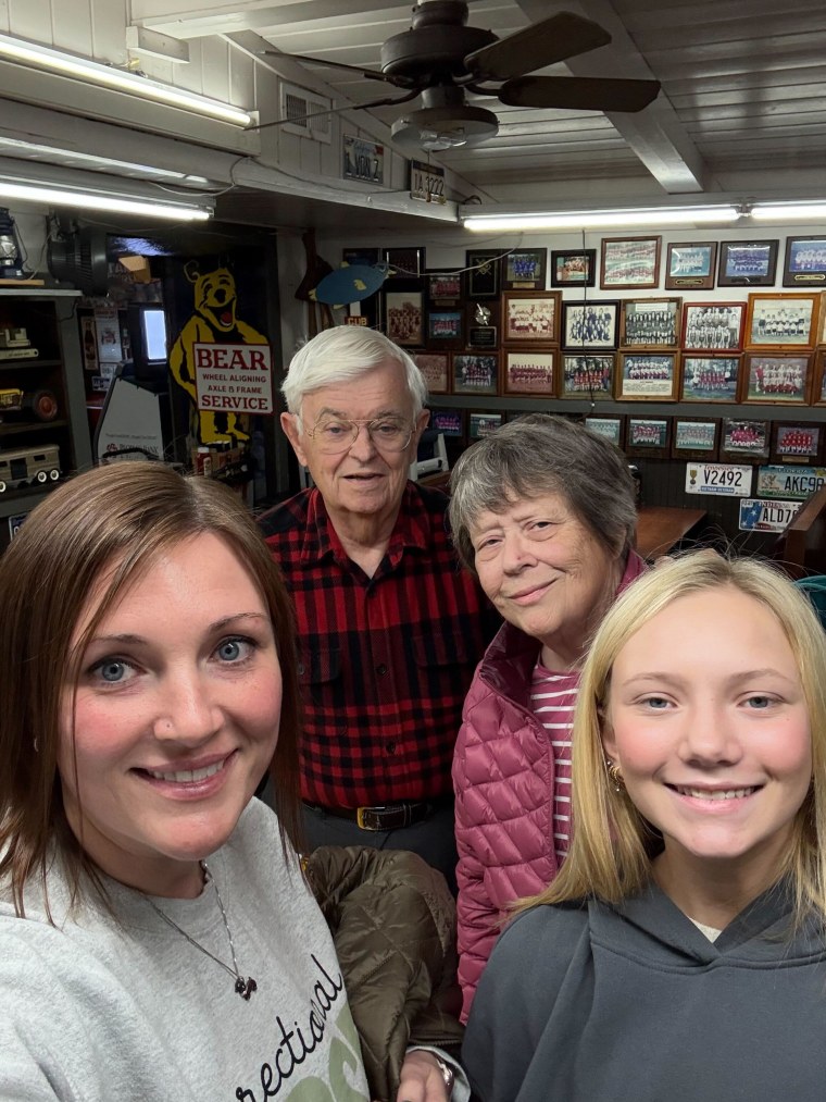 Brittany Smith, Richard Pulley, Brenda Pulley, and Smith's daughter posing together after the GoFundMe check presentation in Manchester, Tennessee