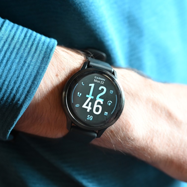 A close-up image of an Apple Watch Series 11 on the wrist of the writer.