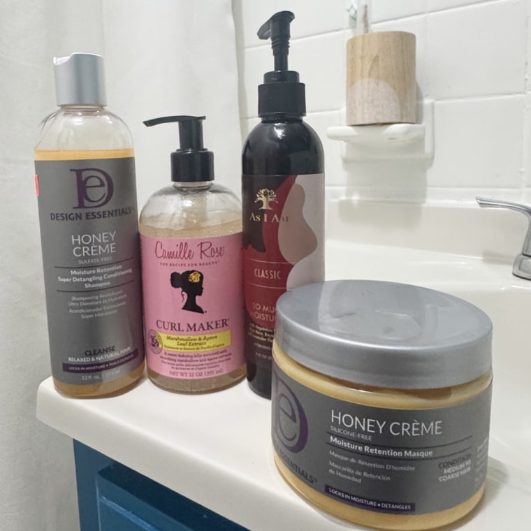 Design Essentials, As I am and Camille Rose natural hair products sitting on top of a bathroom sink