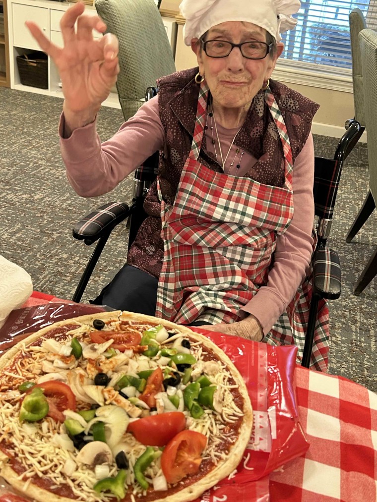 Judy poses with a homemade pizza as part of the Rolling Scones cooking club.